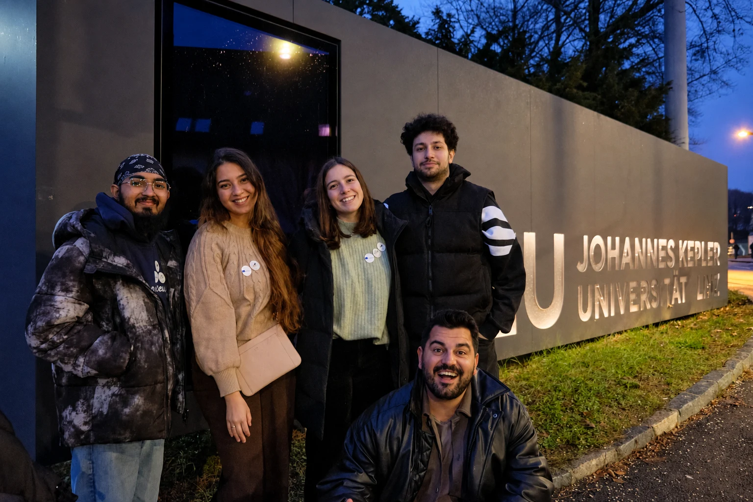 SNL members in front of the Johannes Kepler University Linz sign
